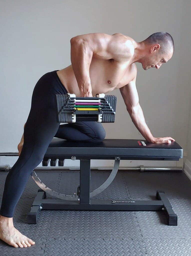 Coach-style dumbbell bench training setup in a home gym